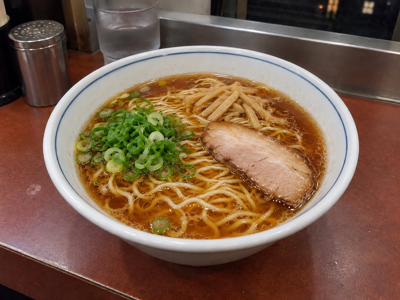 A bowl of ramen on a late-night ramen shop counter